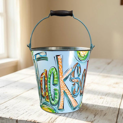 Hand Painted Easter Pail Personalized Name Design Blue Metal Bucket Boy Easter Basket Custom Artwork Durable Construction Egg Hunt Collection Container Candy Storage Solution Toddler Gift Idea Special Holiday Keepsake Spring Celebration